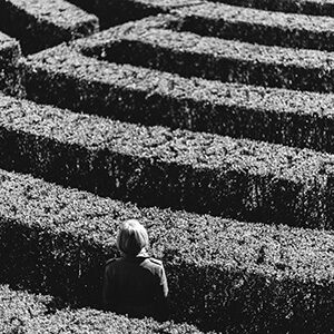 Woman Lookin trough a maze